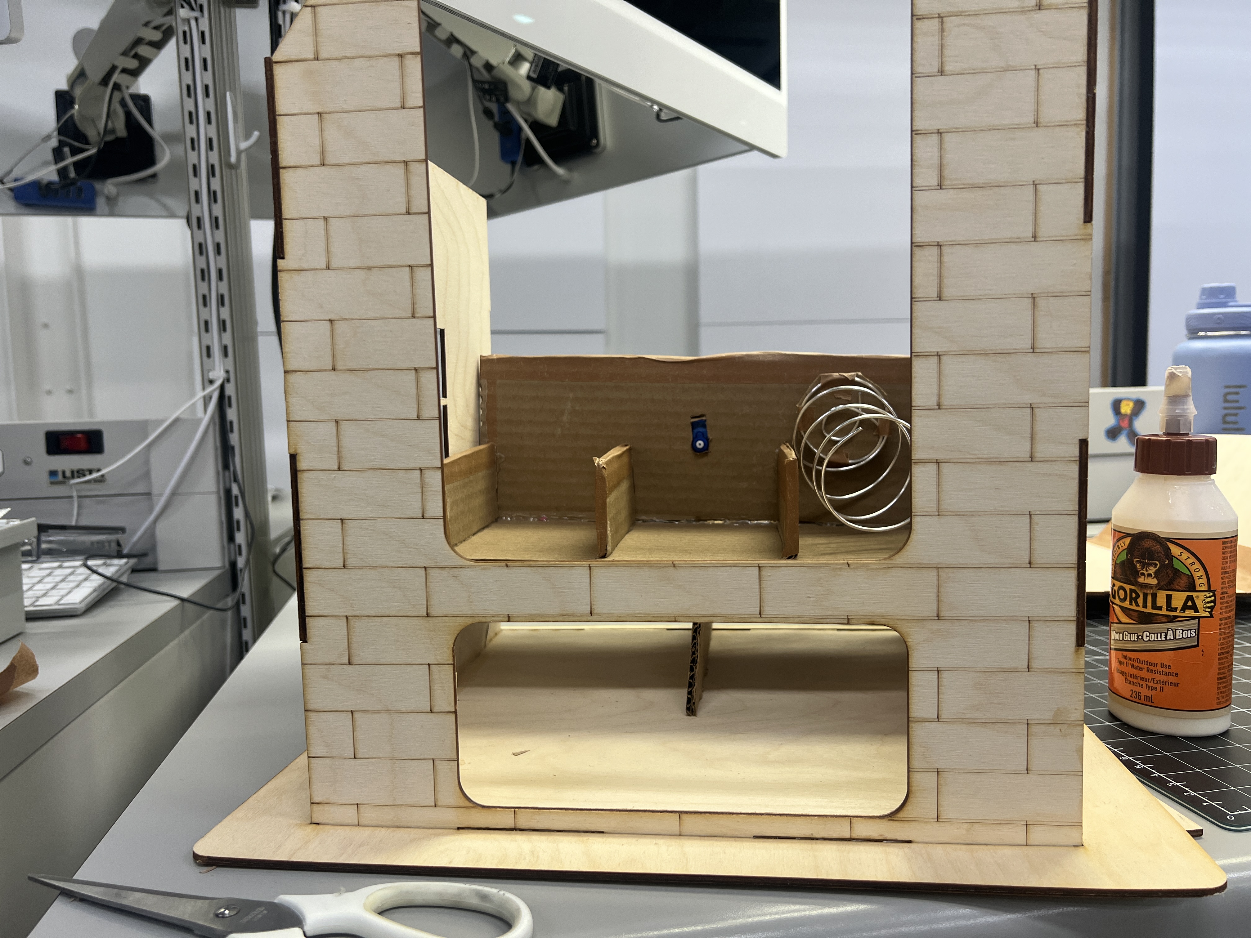 Early cardboard prototype testing the dispensing opening and internal spacing.